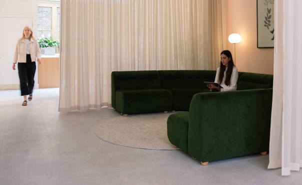 Asset Scope office lounge with a green velvet sofa